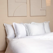 Opgemaakt bed in de kleur wit gemaakt van de stof Tencel